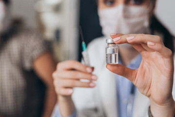 close up doctor holding corona virus vaccine, home care service concept