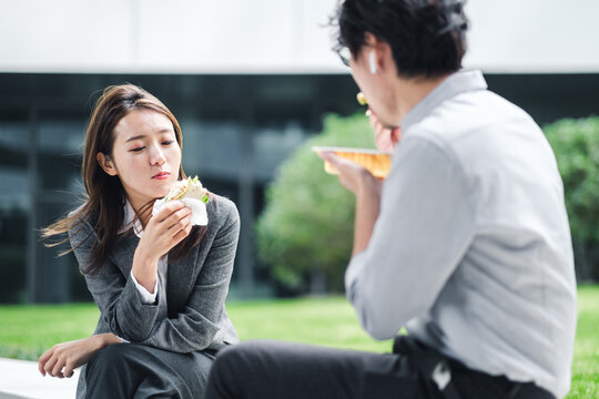 Businessman And Businesswoman Eating Lunch Together