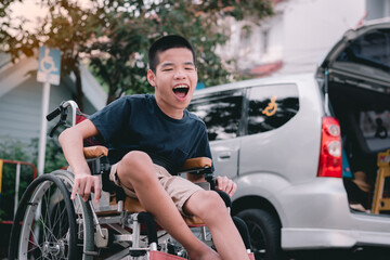 Fototapeta na wymiar Asian special child on wheelchair beside the car on the parking space for disabled people, Life in the education age and public transport of disabled children, Disability kids transportation concept.