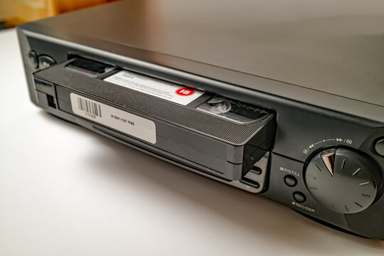 Norwich, Norfolk, UK – November 08 2020. Illustrative editorial photo of a retro VHS video recorder/player and sample video cassette tapes isolated on a white background