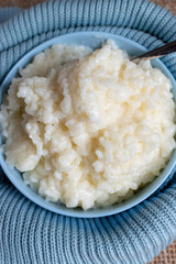 bowl of home made rice pudding with blue tea bowl 