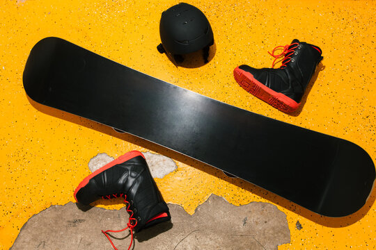 Snowboard kit on the yellow aged floor shot with direct flash light.