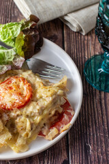 tuna and tomato lasagne with glass of red wine 