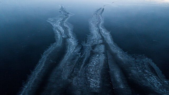 two tracks on the ice of a frozen river