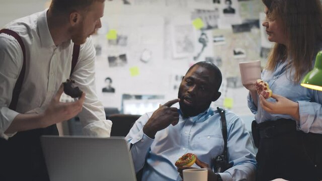 Policemen having chat and meal eating in office on lunch break