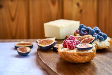Croissant toast with butter and figs. French dip sandwich with berries raspberries for Breakfast. High quality photo