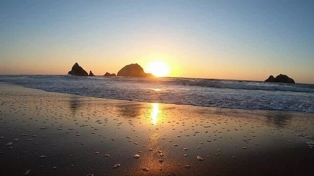 Lands end Lookout viewpoint: View to the Seal Rocks during sunset. Ocean waves on the beach near Sutro Baths. San Francisco California USA - October, 2020.
