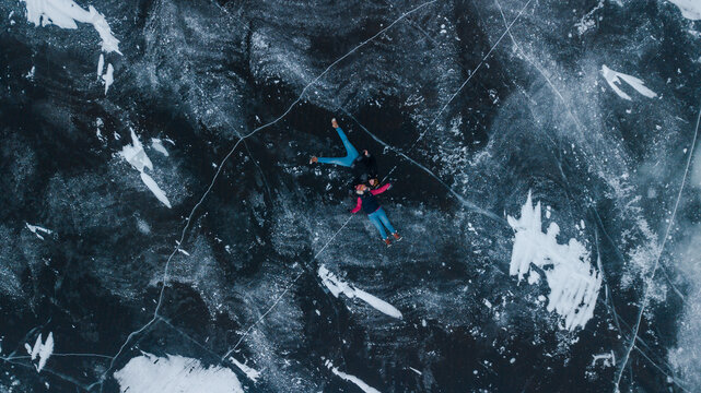 aerial view of a lovely couple in the middle of a frozen river