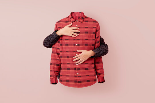 Two caucasian hands hands are wrapped around a pink patterned shirt