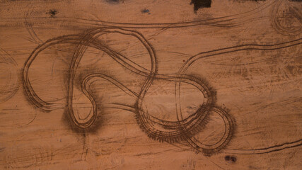 abstract pattern made of sophisticated car traces in the middle of a desert