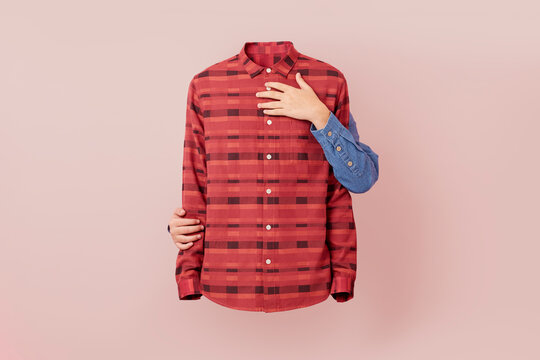 Caucasian hands supportively hold a patterned shirt