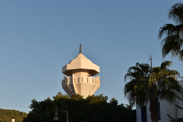 minaret of a mosque among trees