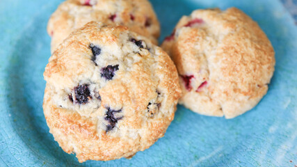 Assorted berry scones on blue plate