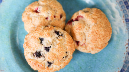 Assorted berry scones on blue plate