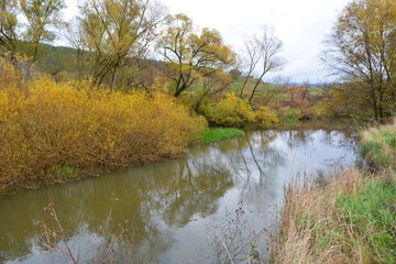 Autumn landscape with a small river