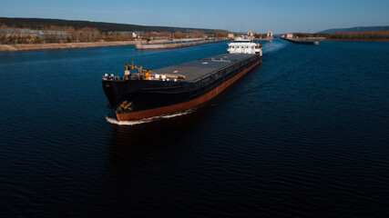 Top-view of a cargo ship passing by the gateway