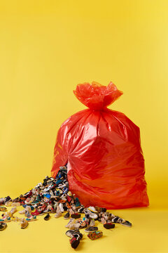 A large red bin bag splits open spilling a glut of trainers and shoes
