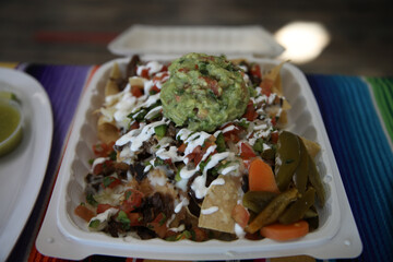Nachos in a takeout container 