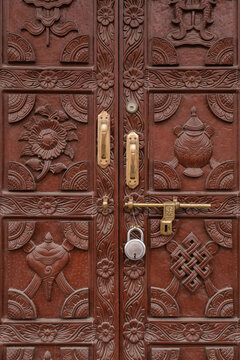 old wooden door in Nepal, decorated with traditional ornament
