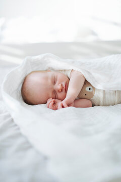Cute Infant In Bodysuit Sleeping Under Blanket