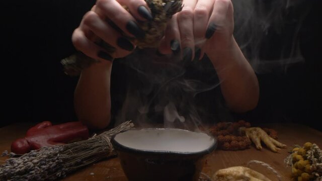 extreme close-up, detailed. hands of a witch with black nails above a bowl of thick white smoke.