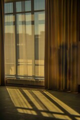 background of Contrast sun light from a window from window frame with curtains Sunset rays on stone...