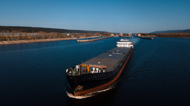 Top-view of a cargo ship passing by the gateway