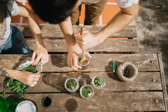 Unrecognizable man preparing mojitos from above