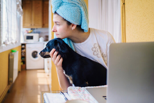 Woman Working From Home On The Computer With Her Dog.