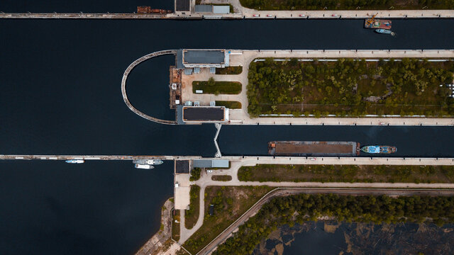 Top-view of a barge ship passing by the gateway