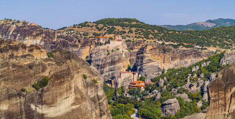 Fototapeta na wymiar Beautiful panorama of landscapes with monasteries (Varlaam, Rousanou, and Great Meteoron) and spectacular rock formations in Meteora, Greece