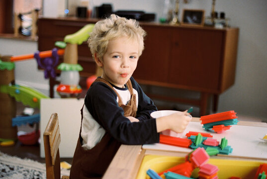 little boy playing with stitch color blocks in his playroom