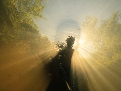 Selfie Silhouette Of a freediver with a golden sunset glow
