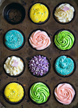 Set of delicious multicolored cupcakes