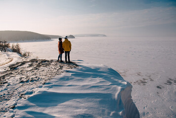 Winter love story. Young couple having fun in the mountains
