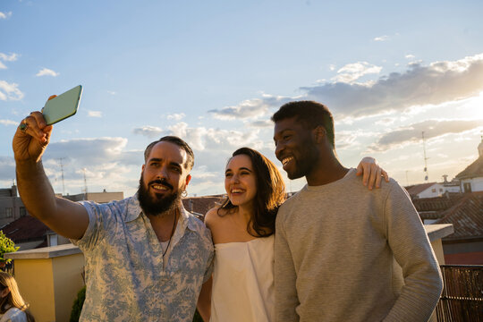 Friends Taking A Selfie At Sunset.