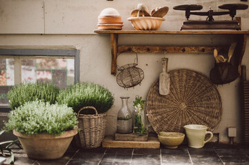 old rural rustic country kitchen with herbs, vintage egg basket, cups and more