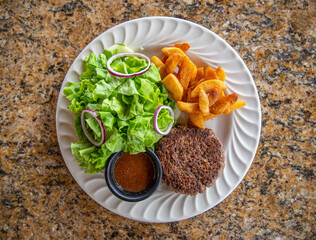 Hamburger Patty with green salad and steak fries