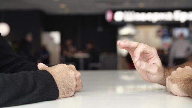 Close up of male hands during effective negotiations. Media. Hands of two men moving during talking, concept of business and making agreement.