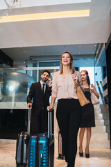 Business people arriving at hotel.