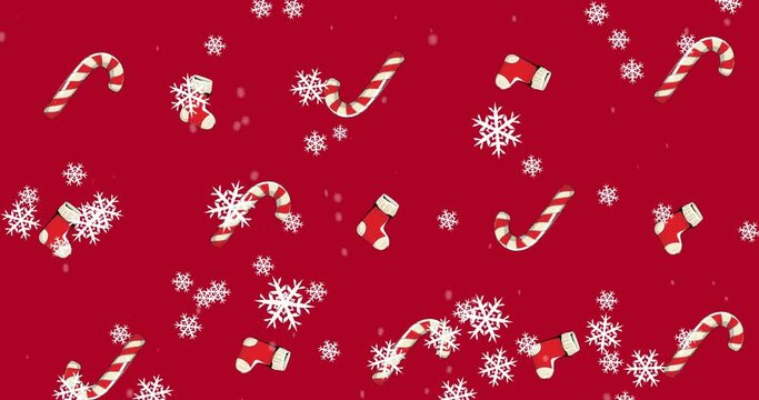 Animation of candy canes and christmas stockings with snow falling on red background