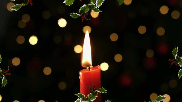 Digital animation of christmas wreath decoration over burning candle against spots of lights
