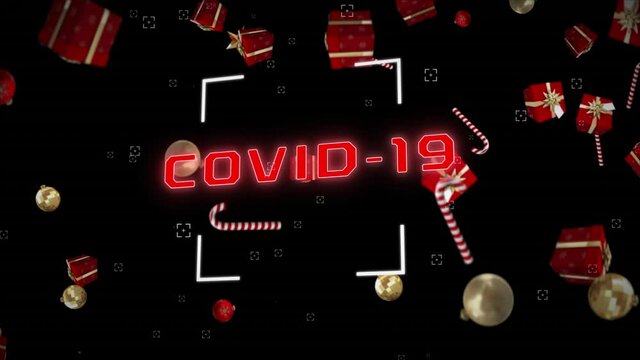 Animation of covid 19 text with candy canes and christmas decorations falling on black background
