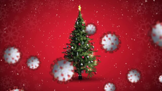 Animation of covid 19 cells moving over winter scenery with christmas tree and snow falling