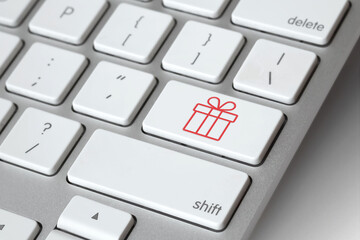 Christmas online shopping. Keyboard with gift symbol key - online Christmas present shopping concept. E-commerce concept. Computer, laptop. Shop online, buy now