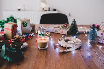 christmas decoration, gift wrapping and lights on the table