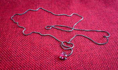 Silver pendant and choker with a heart shaped gem