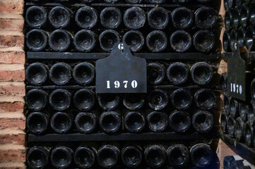 Bottles of vintage fortified ruby or tawny porto wine in old cellars of Vila Nova de Gaia, Portugal