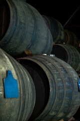 Old porto lodge with rows of oak wooden casks for slow aging of fortified ruby or tawny porto wine in Vila Nova de Gaia, Portugal