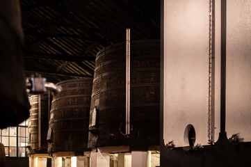 Old porto lodge with rows of concrete vats of fortified ruby or tawny porto wine in Vila Nova de Gaia, Portugal